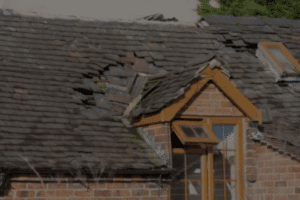 Storm-damaged roof with broken and missing shingles