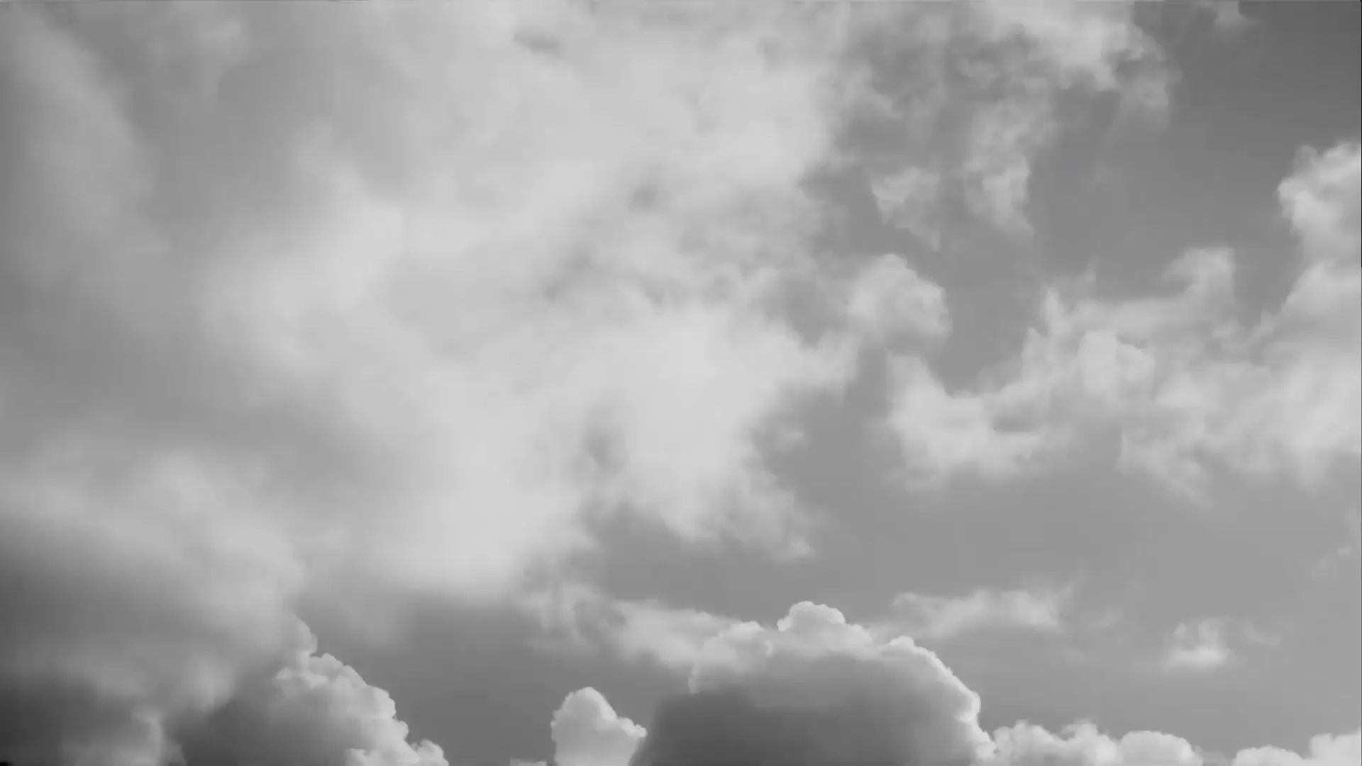 A black and white photo of some clouds in the sky